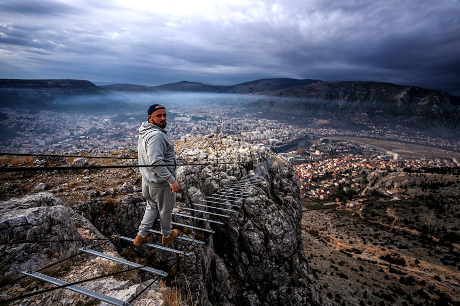 A man looks back while walking on a narrow mountain trail above Mostar, Bosnia