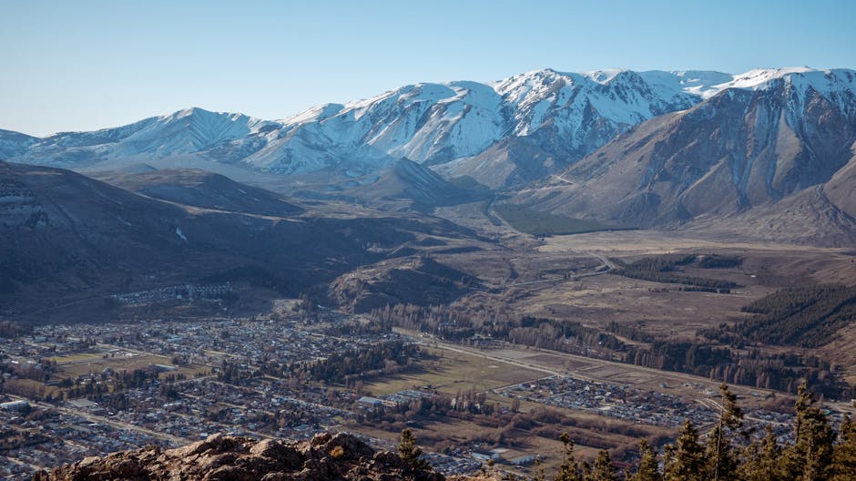 Breathtaking aerial view of a town against snow-capped mountain backdrop